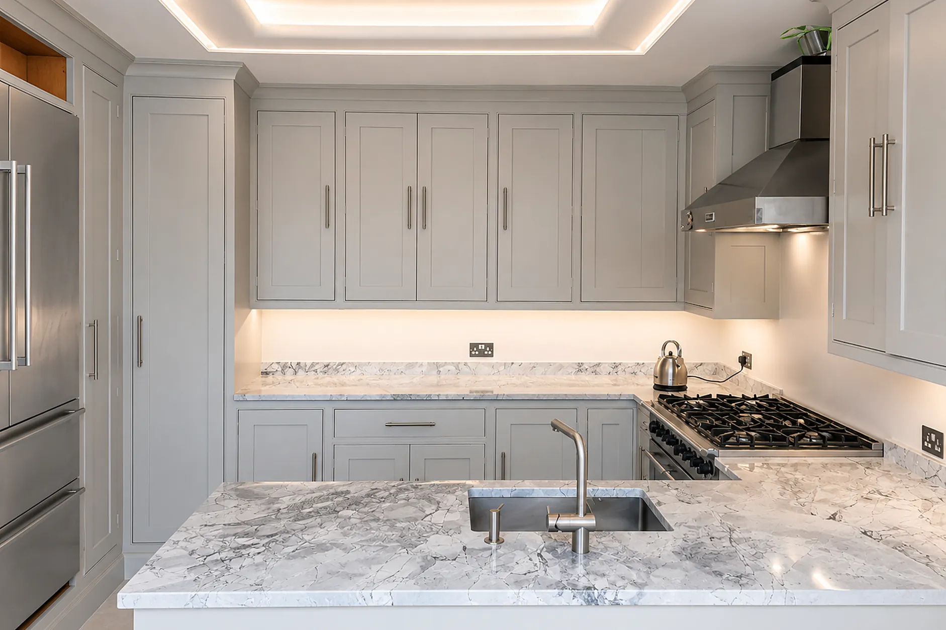 Hand-painted in-frame kitchen with marble worktops and island